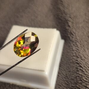 Topaz 5.5ct oval 14x10mm checkered cut